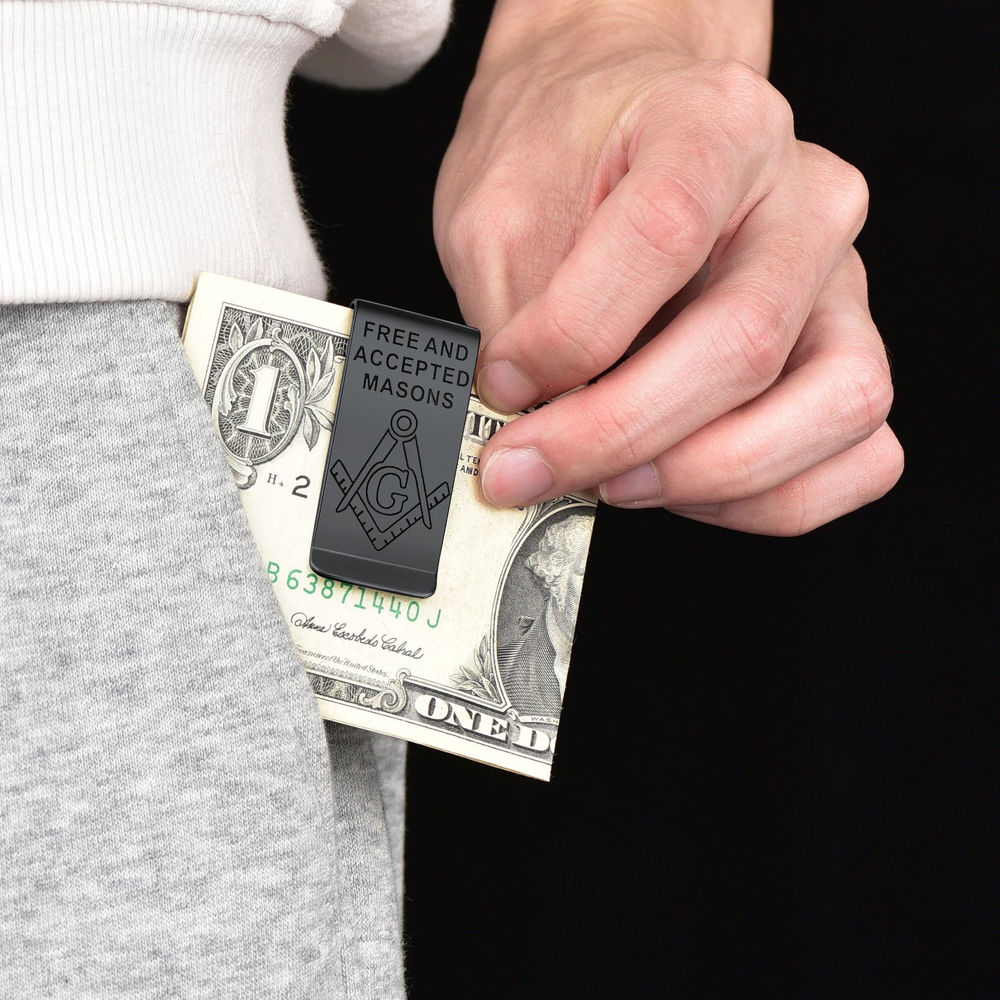Masonic money clip holding a dollar bill