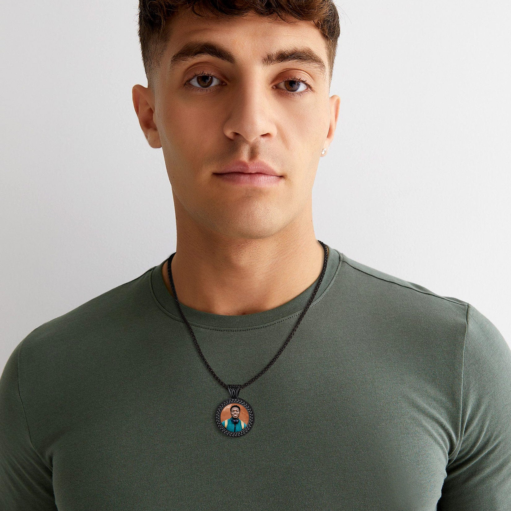 Personalized photo pendant necklace on olive green shirt