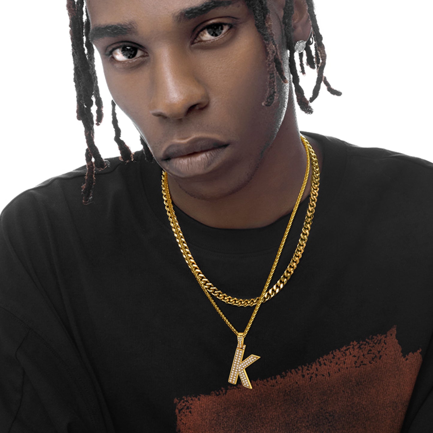 Man wearing a gold letter K pendant necklace with cubic zirconia