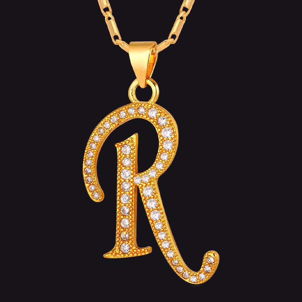 Gold Cubic Zirconia Initials R Necklace with a letter 'R' pendant on a black background