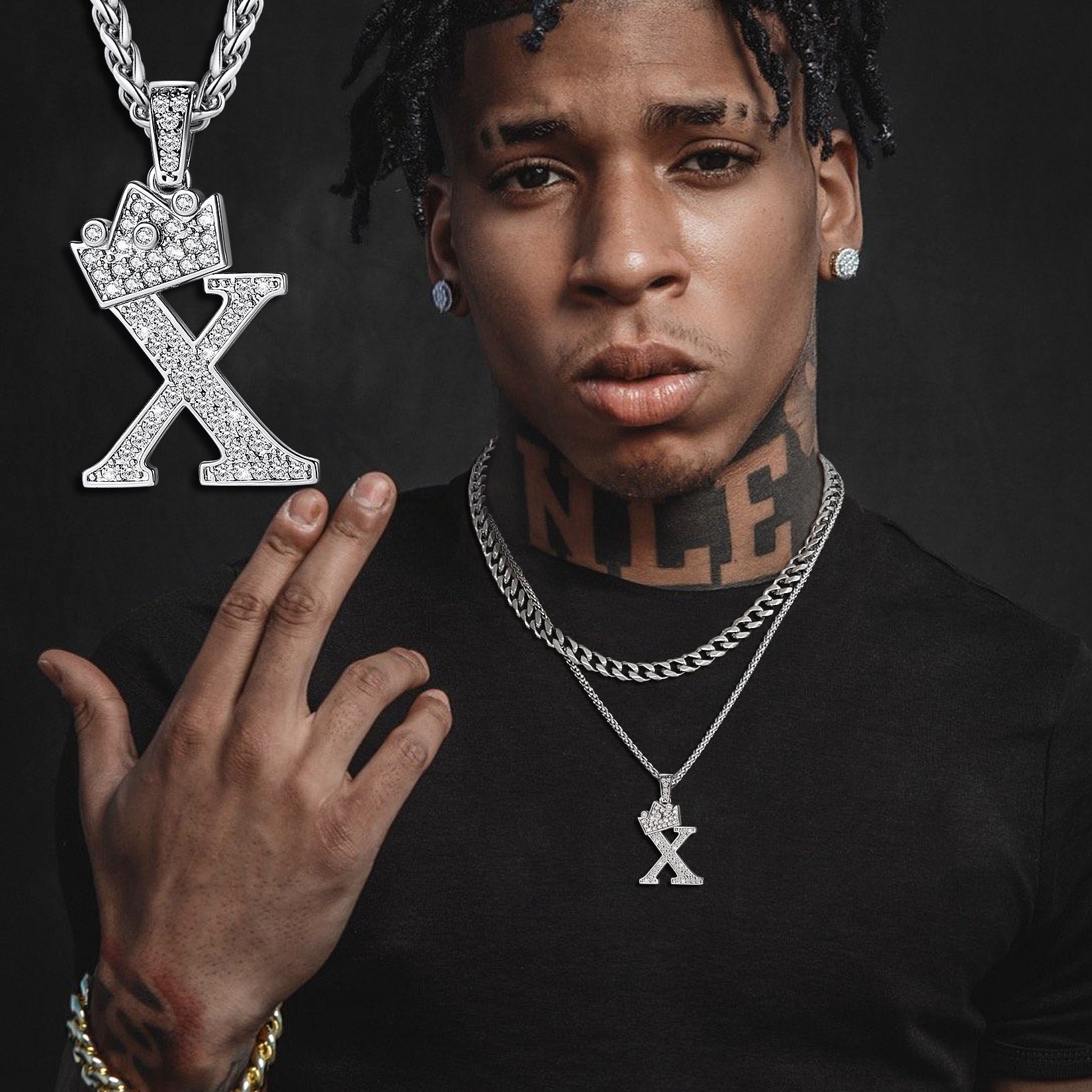 Man wearing a cz initial necklace with a 'X' pendant on a dark background