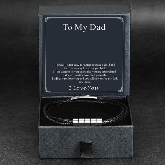 Bracelet in a black box with a message to 'My Dad' on a dark backgroundimg