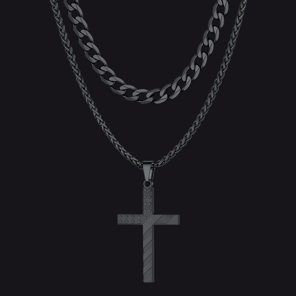 Black chain necklace with a cross pendant on a black background