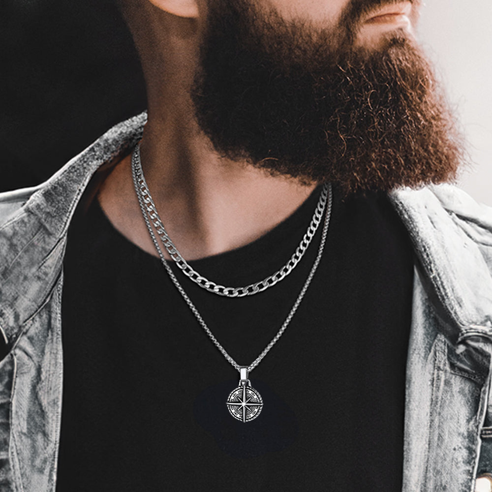 Model pairing Cuban chain and compass pendant necklace with streetwear look.