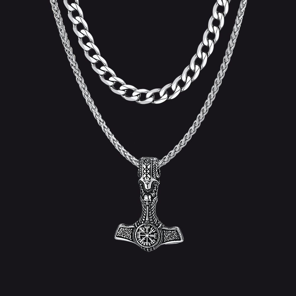 Cuban chain and Thor’s hammer pendant necklaces on flat lay with Viking props.