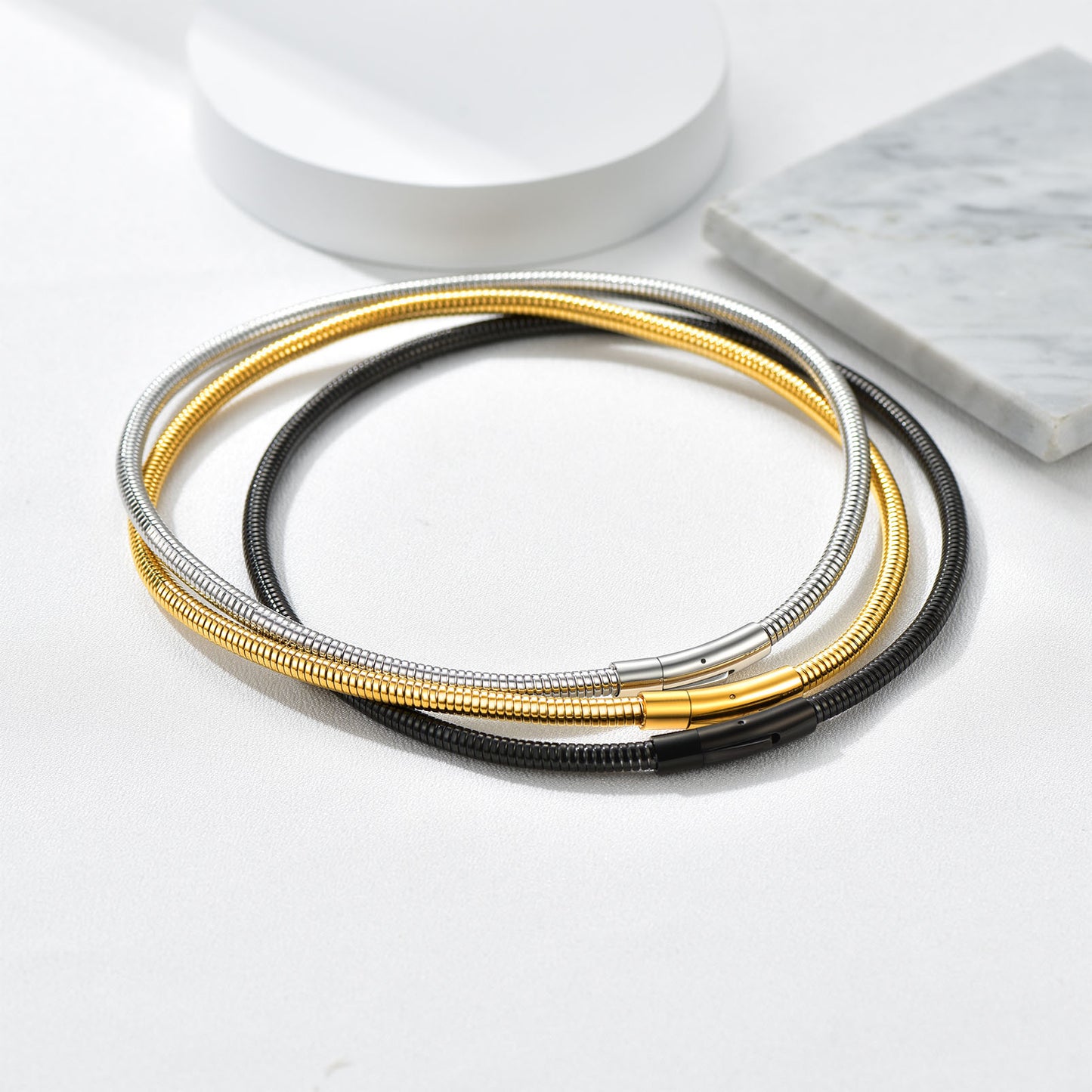 Herringbone snake chain necklaces in gold, black, and silver