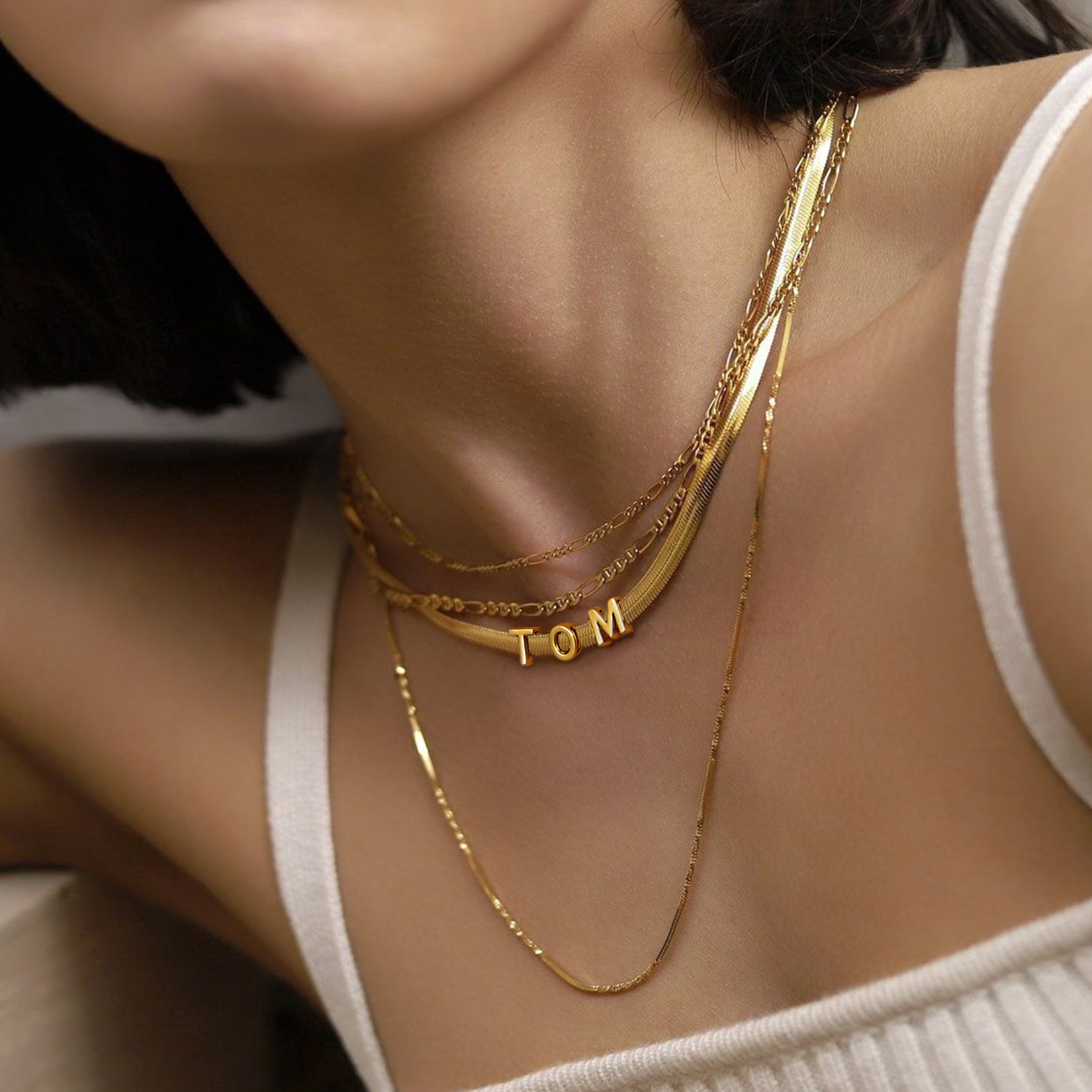 Model wearing engraved name choker chain in gold