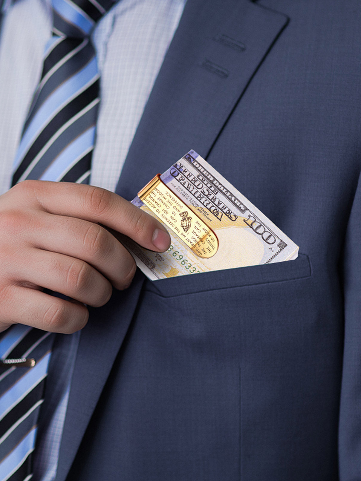 Man in suit putting money clip with prayer into pocket.