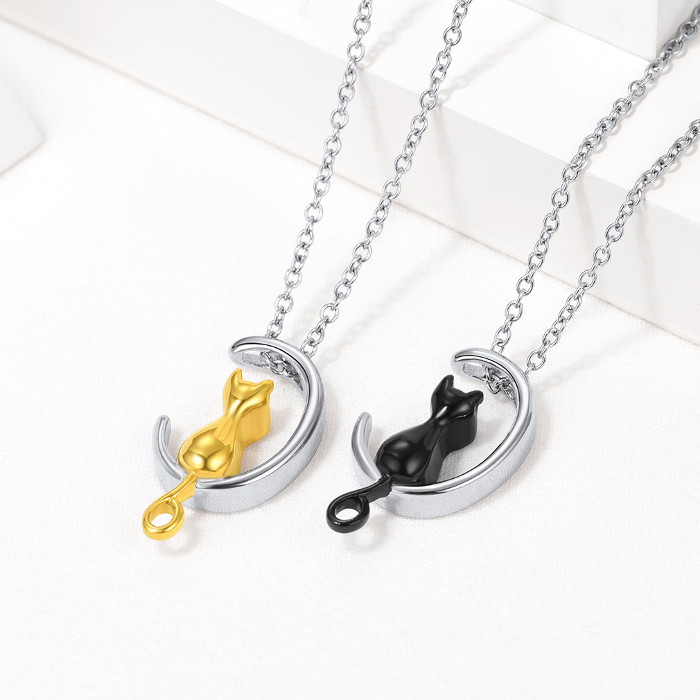 Gold and black cat urn necklaces displayed
