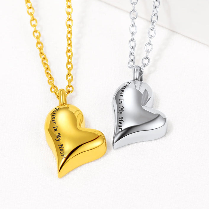 Flat lay of engraved heart pendant in silver/gold