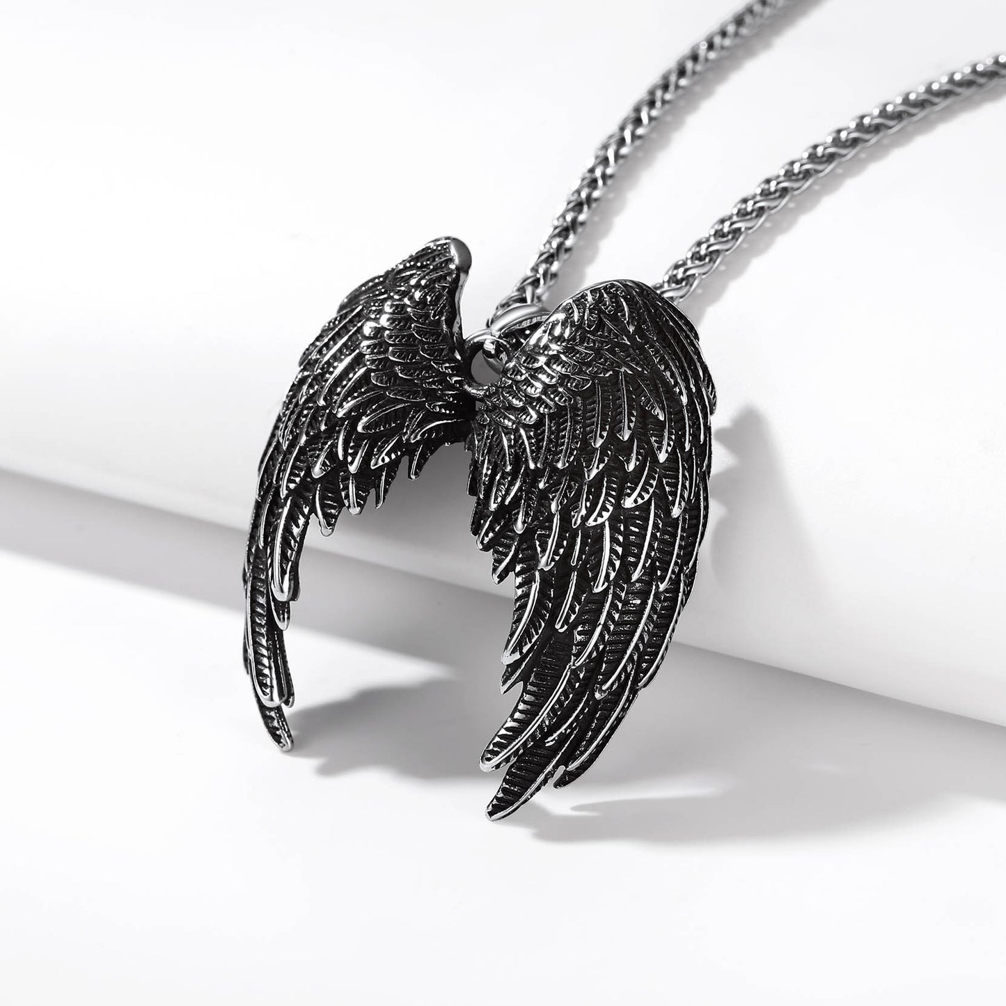 Black angel wings pendant necklace with detailed feather design
