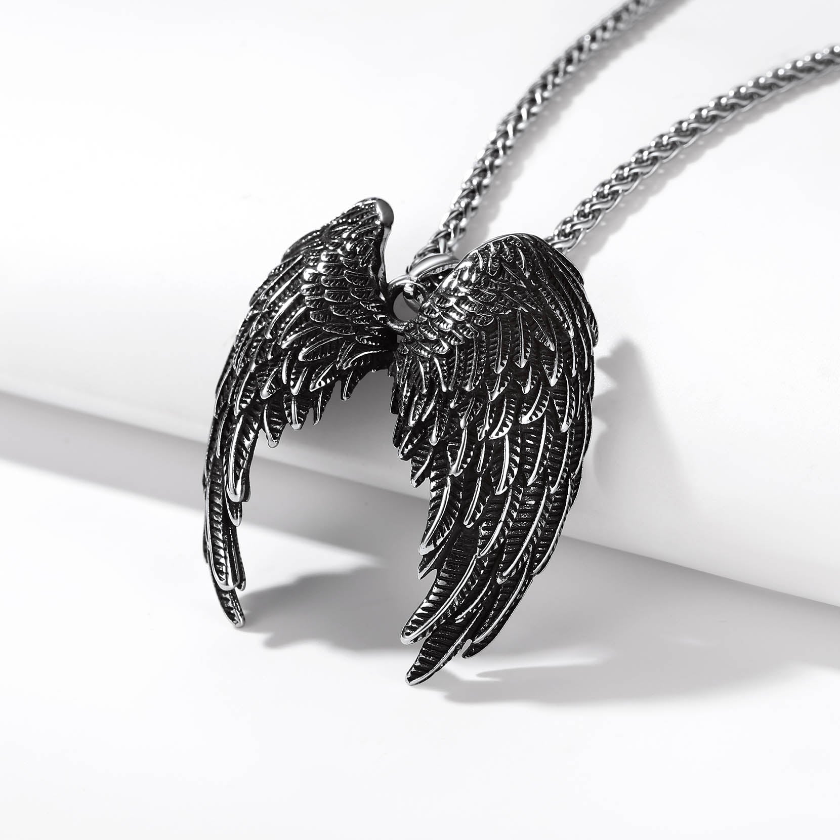 Black angel wings pendant necklace with detailed feather design
