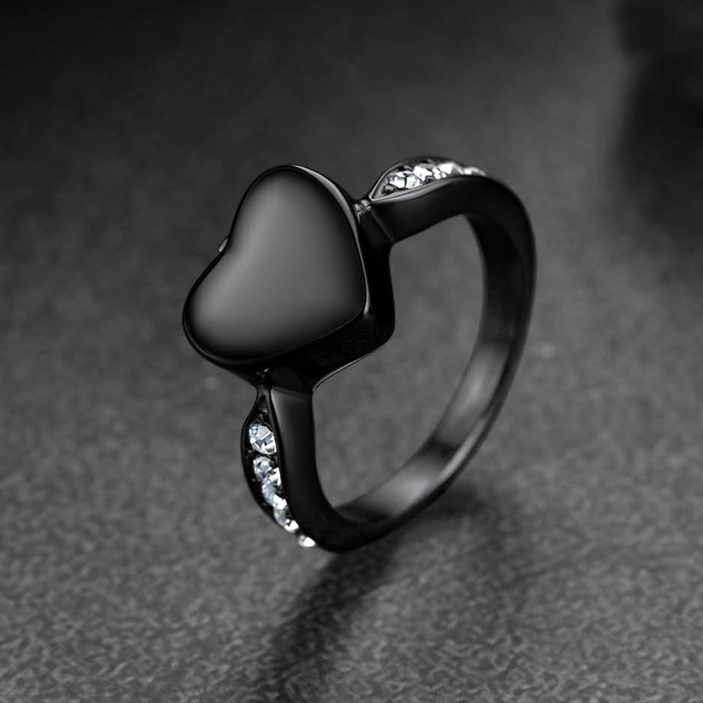 Black heart-shaped ring with gemstones