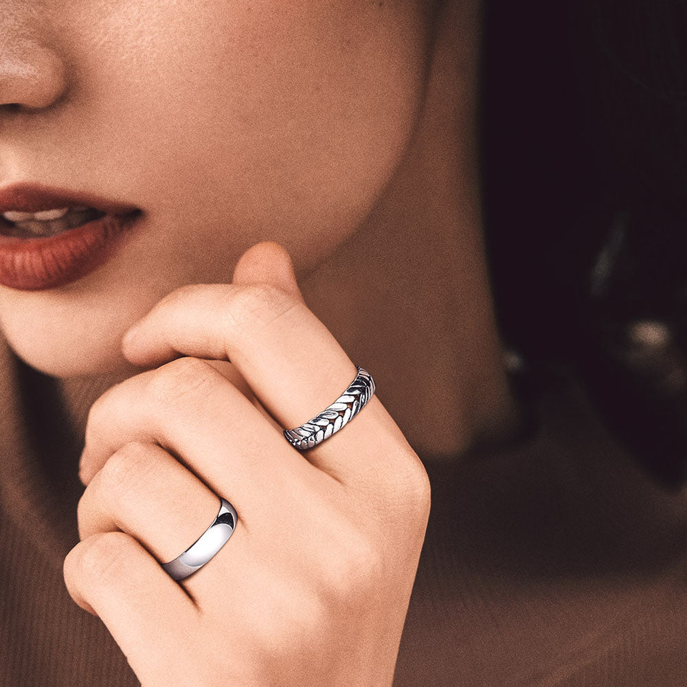 Woman's hand wearing sterling silver wheat chain rings