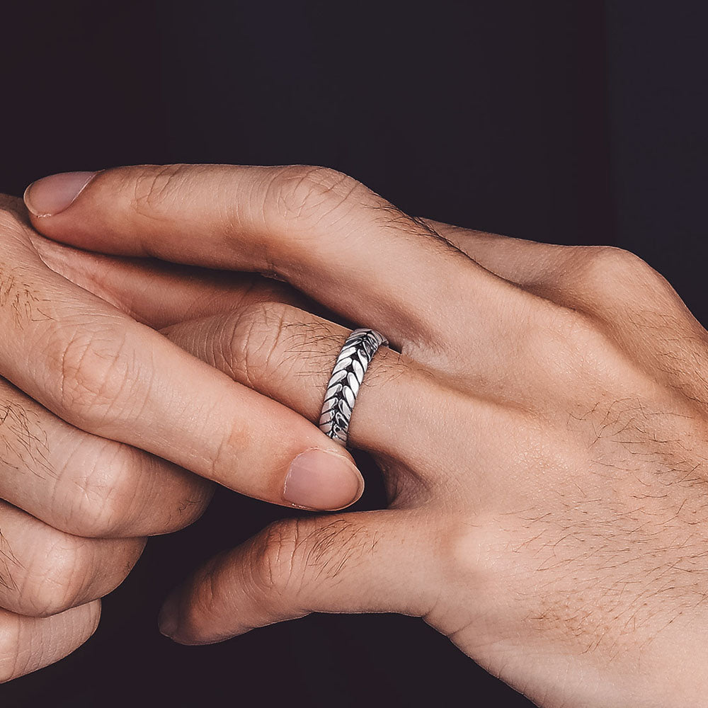 Man's hand with sterling silver wheat chain ring, chunky band design