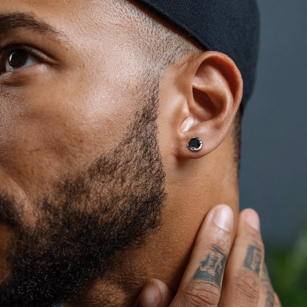 Close-up of a man wearing a black earring with a blurred background