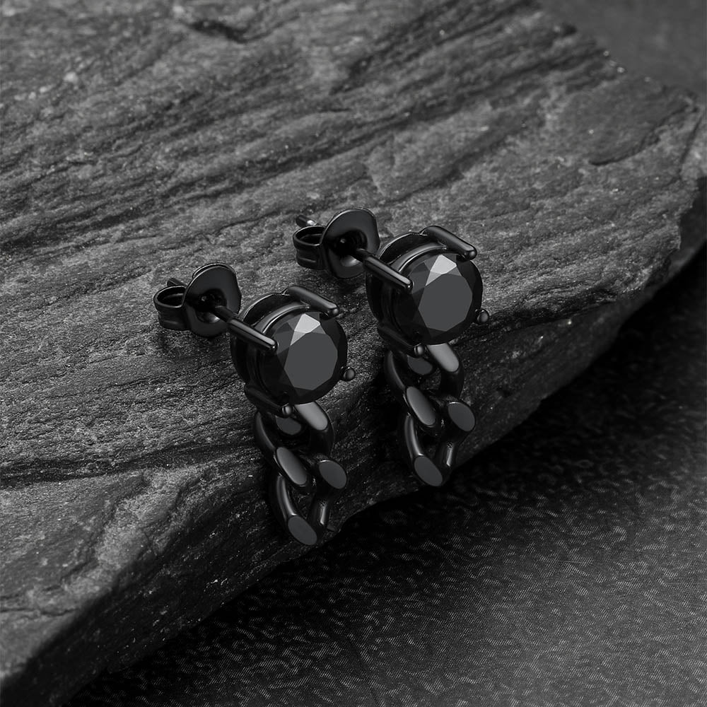 Black cz chain earrings on a dark stone surface