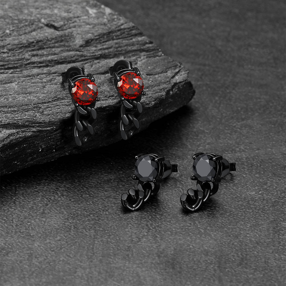 Black and red gemstone Black Cubic Zirconia Chain Link Earrings on a dark stone surface