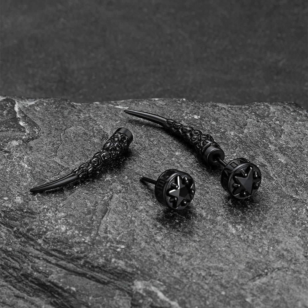 Black Nordic Star Rune Fang Stud on a textured stone surface