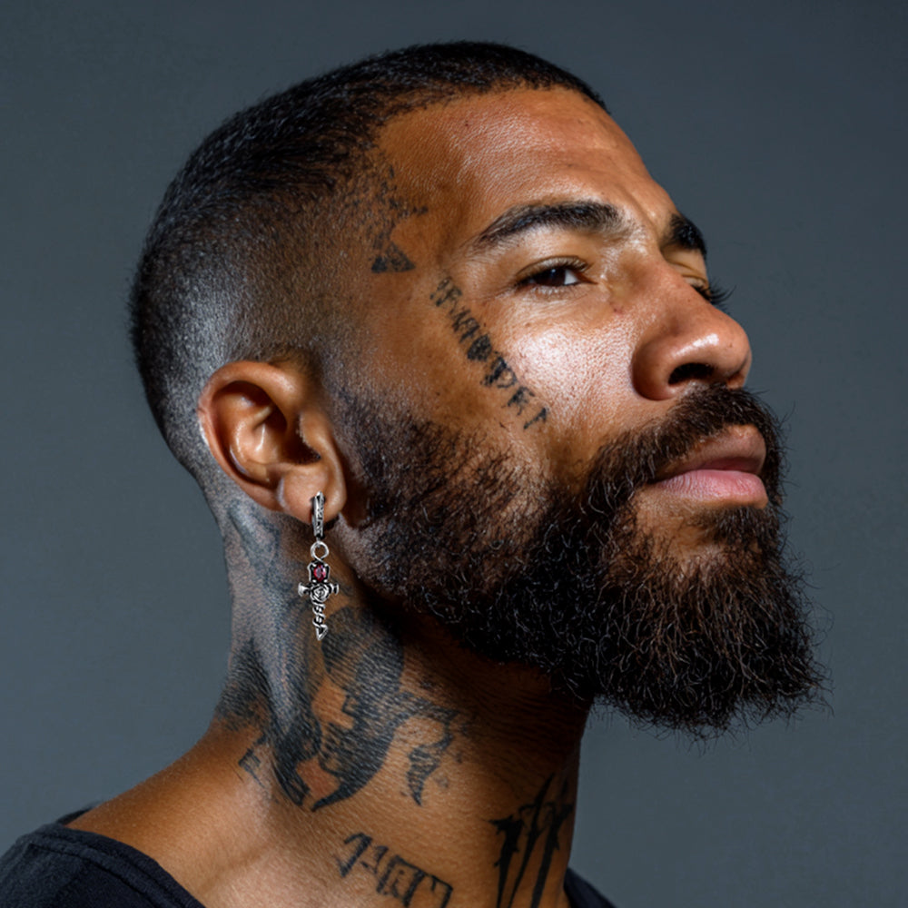 Man with tattoos on neck and face wearing Rose Skull Cross Drop Earrings