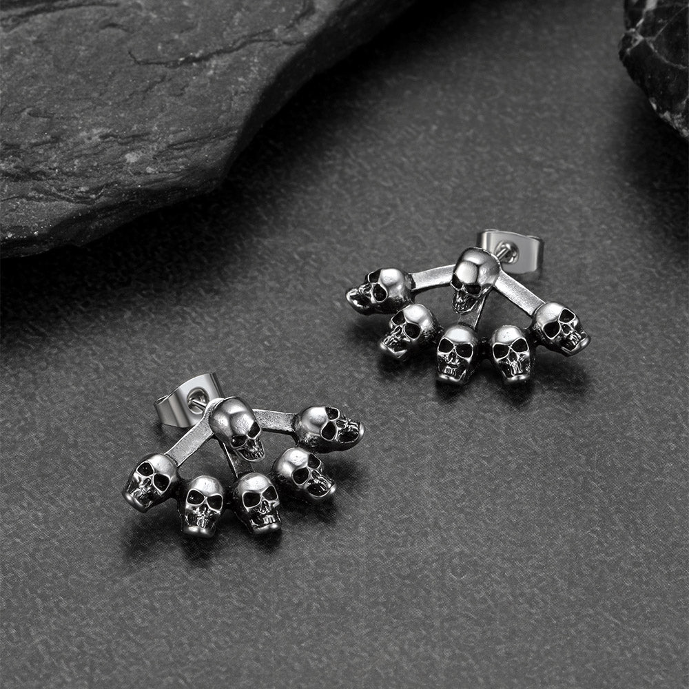 Gothic multiple skull stud earrings photographed with Halloween props.