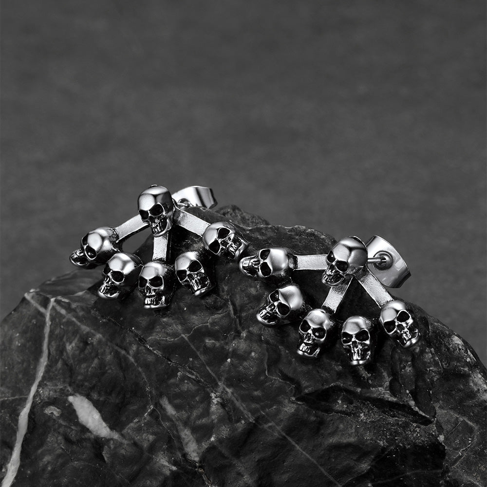 Skeleton skull stud earrings displayed with gothic jewelry collection.