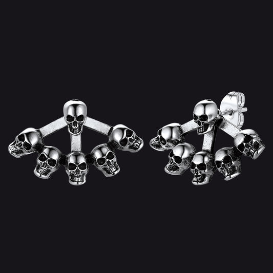 Gothic style skull head stud earrings for men on dark textured background.img