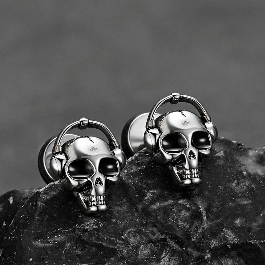 Pair of Halloween skull stud earrings for men laid flat with Gothic vibe