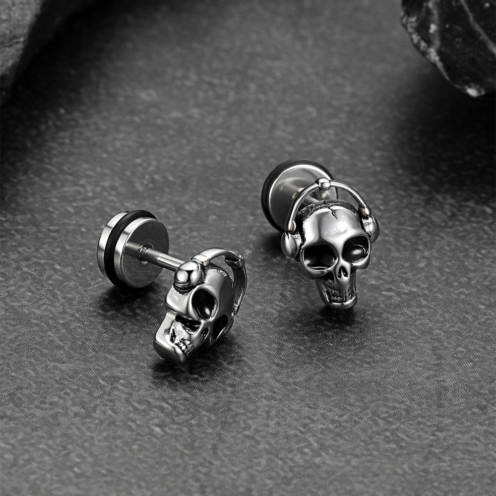 Close-up side view of man wearing Gothic skull stud earrings