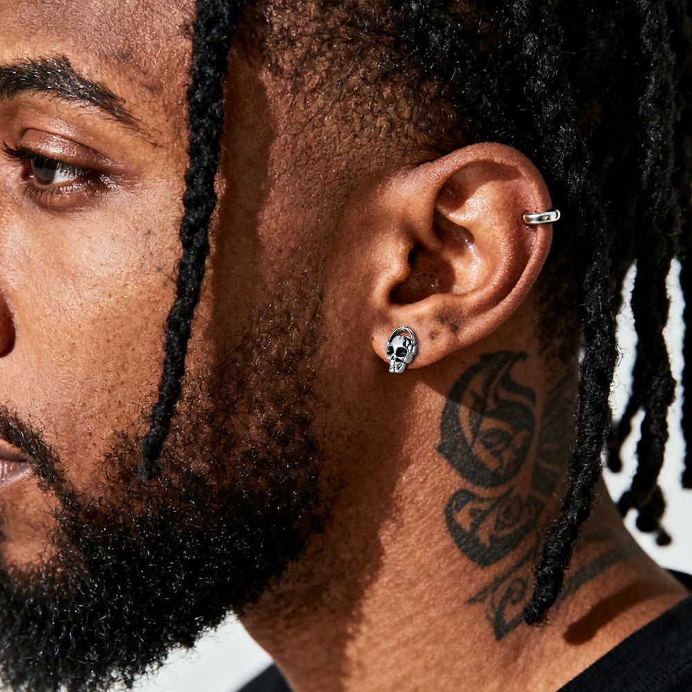 Close-up of a man's wearing Music Skull Stud Earrings