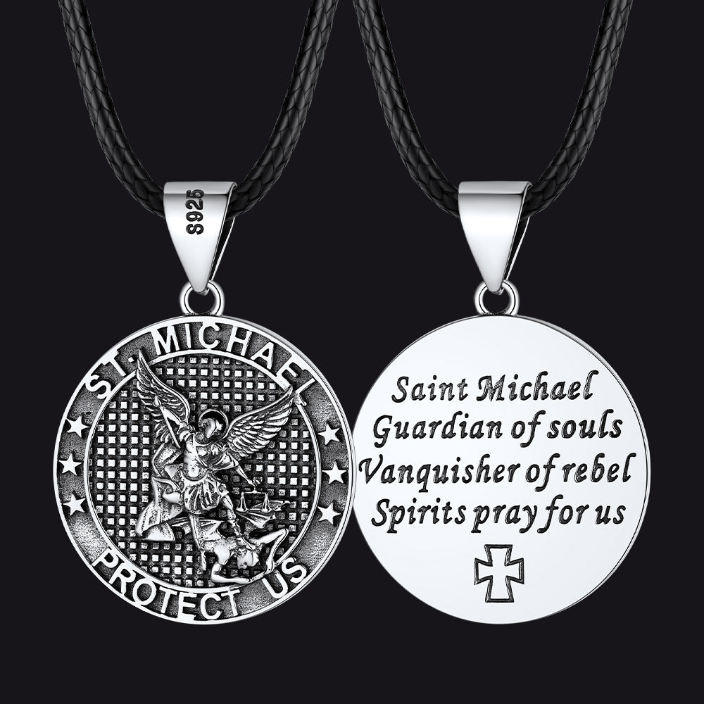 Two St. Michael pendant necklaces on black cords with engraved text.