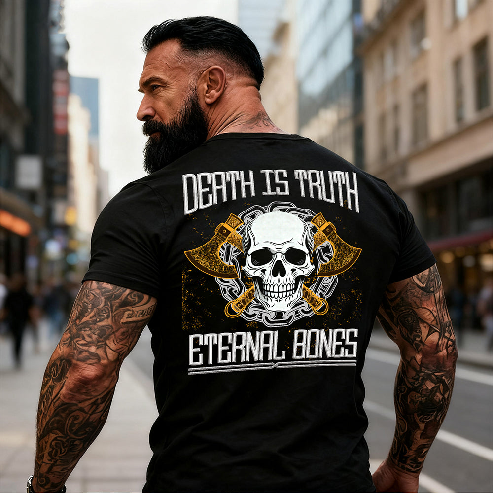 Man wearing a black t-shirt with a skull design and text on the back, standing in an urban setting.