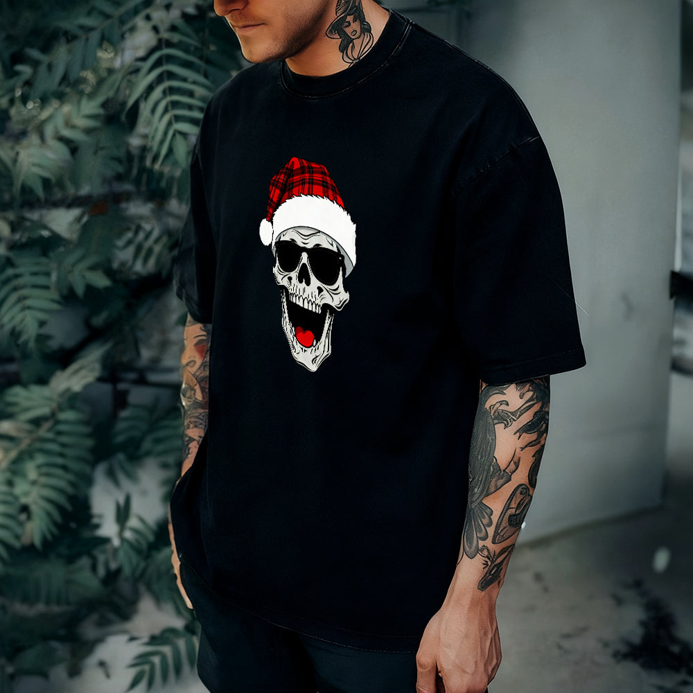 Person wearing a black t-shirt with a skull design wearing a Santa hat.