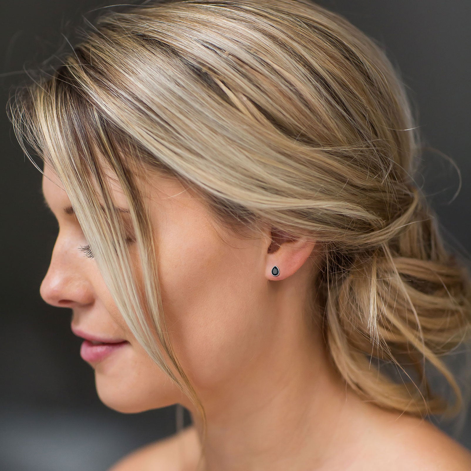 Woman wearing silver water drop cubic zirconia stud earrings