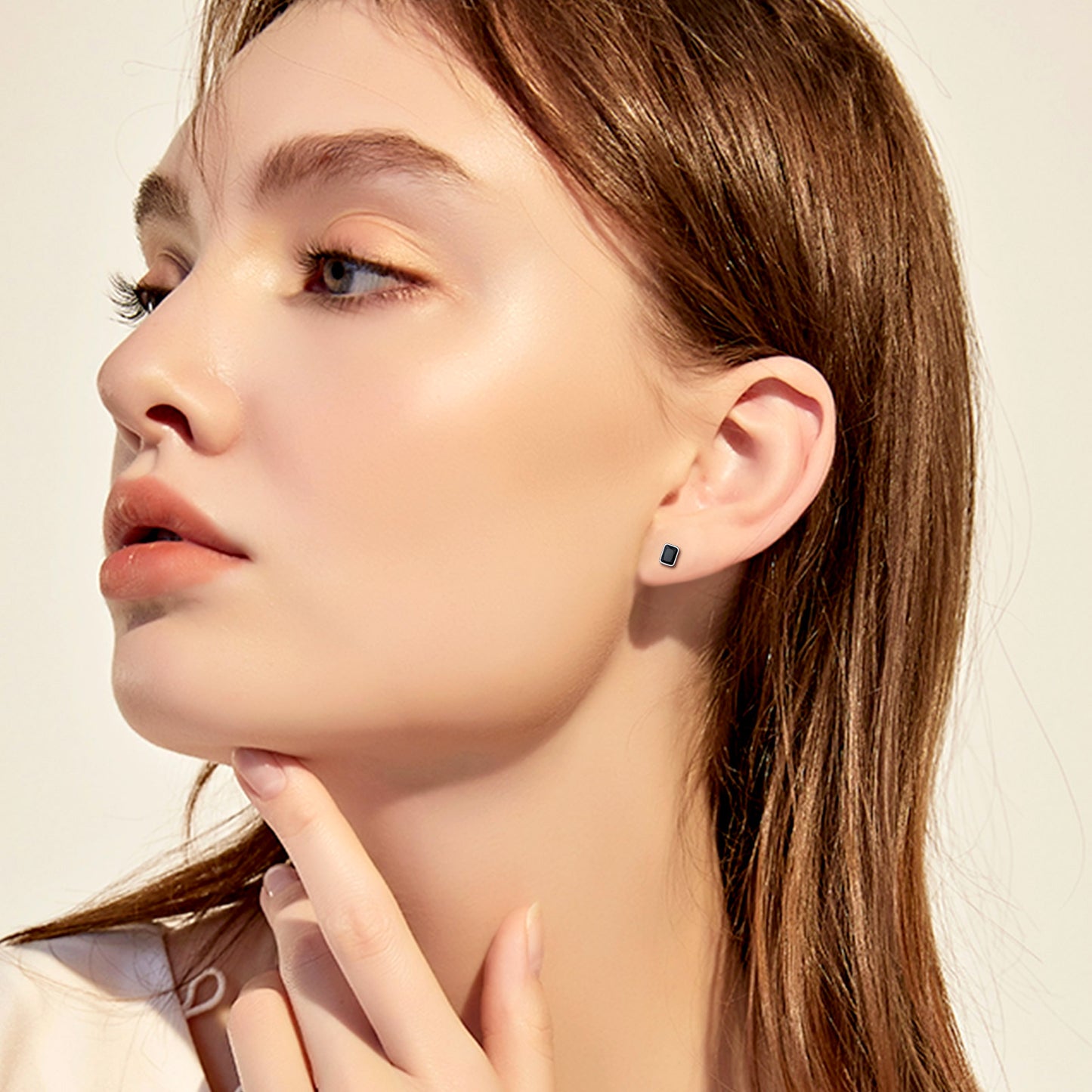 Woman wearing sterling silver stud earrings with black CZ stone