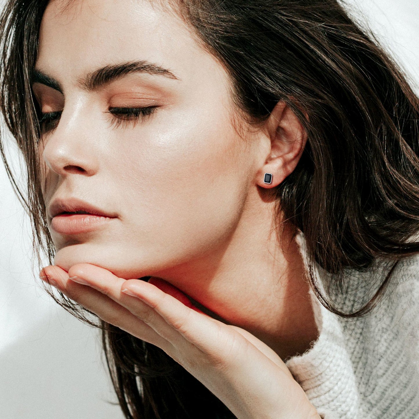 Woman wearing sterling silver stud earrings with black CZ stone