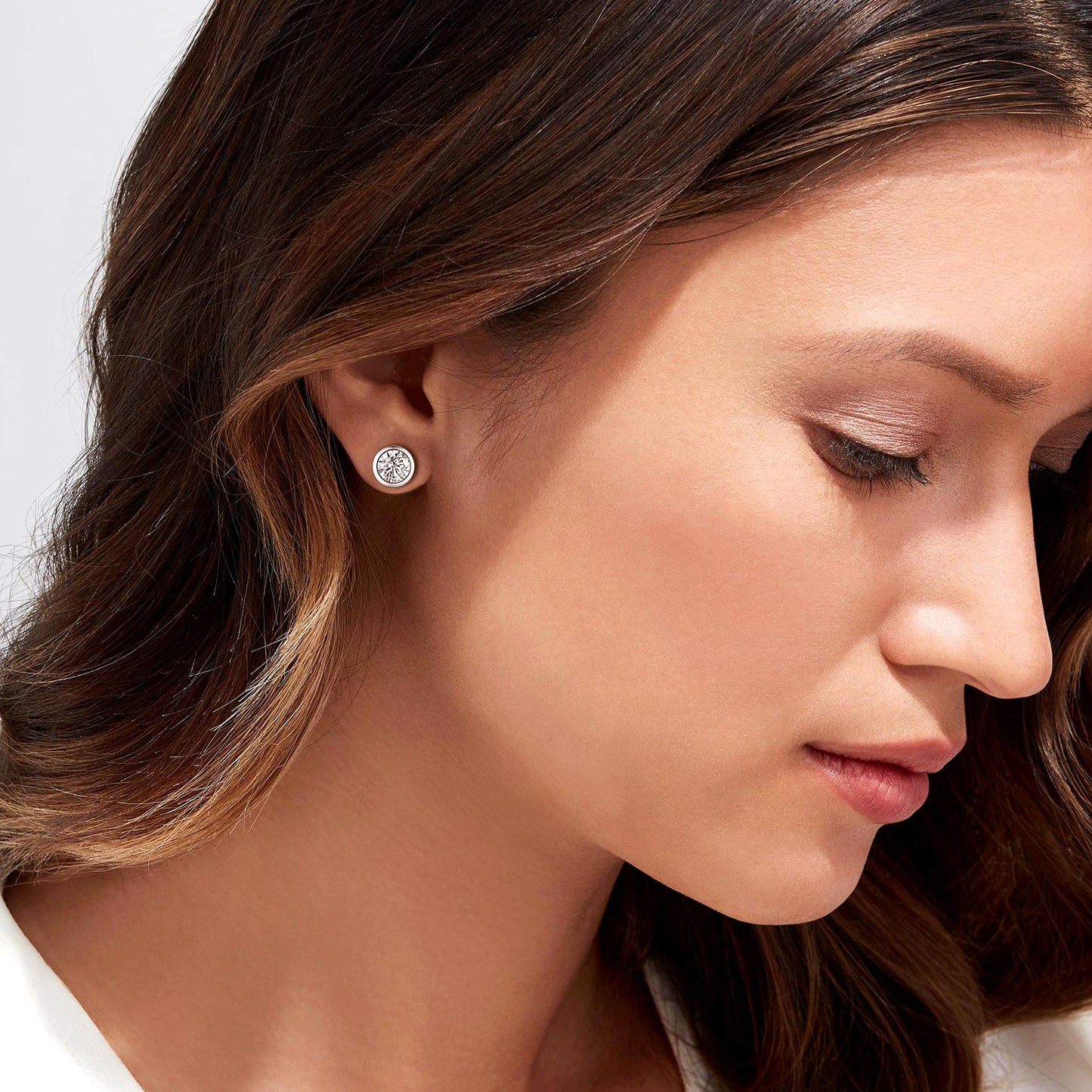 Woman wearing sterling silver cubic zirconia stud earring