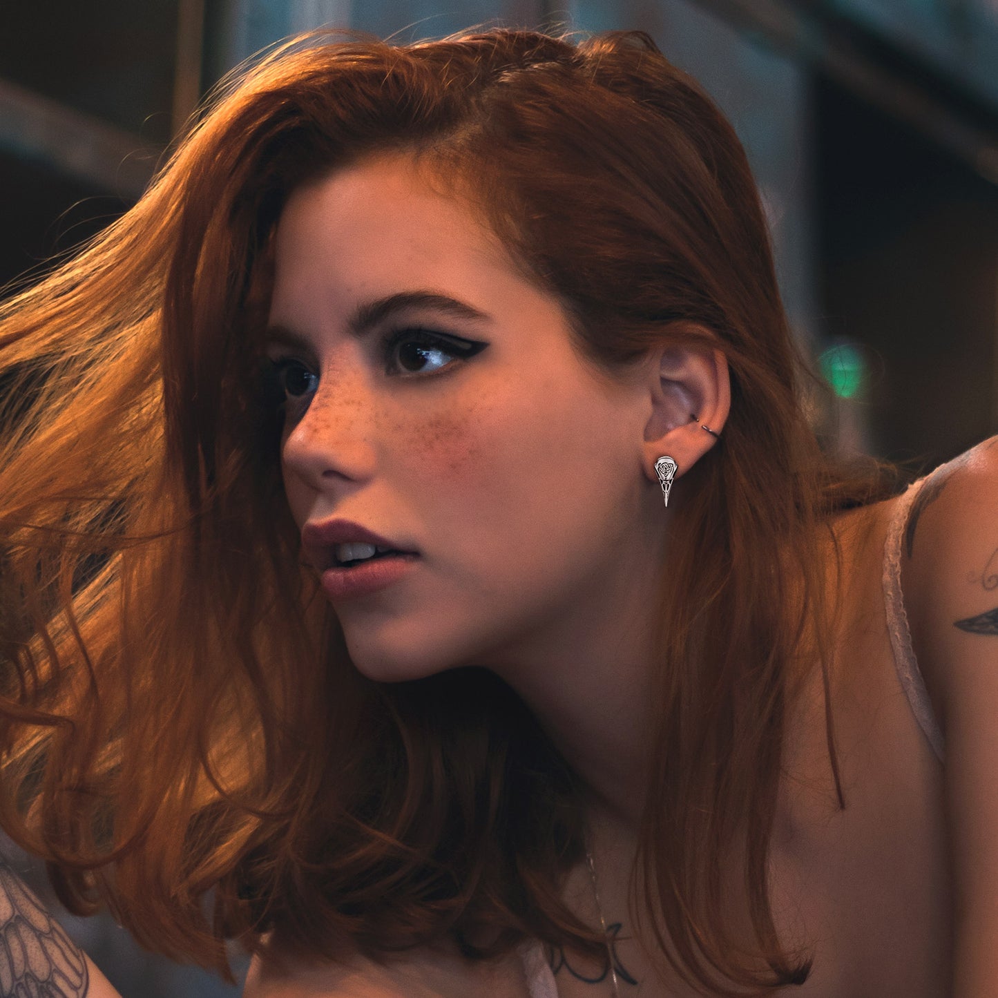 Woman wearing Viking Raven Skull Stud Earrings