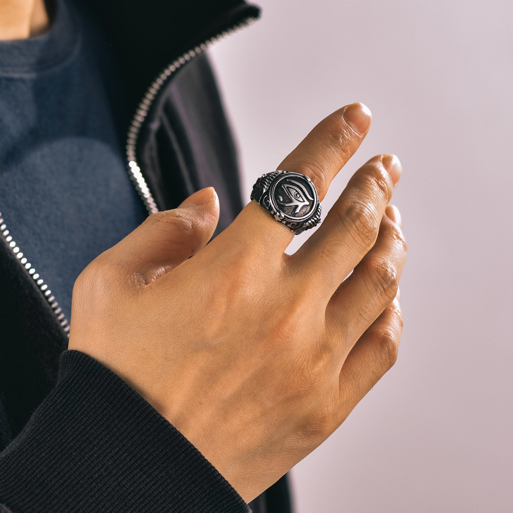 Man's hand wearing an Ancient Egyptian Eye of Ra signet ring