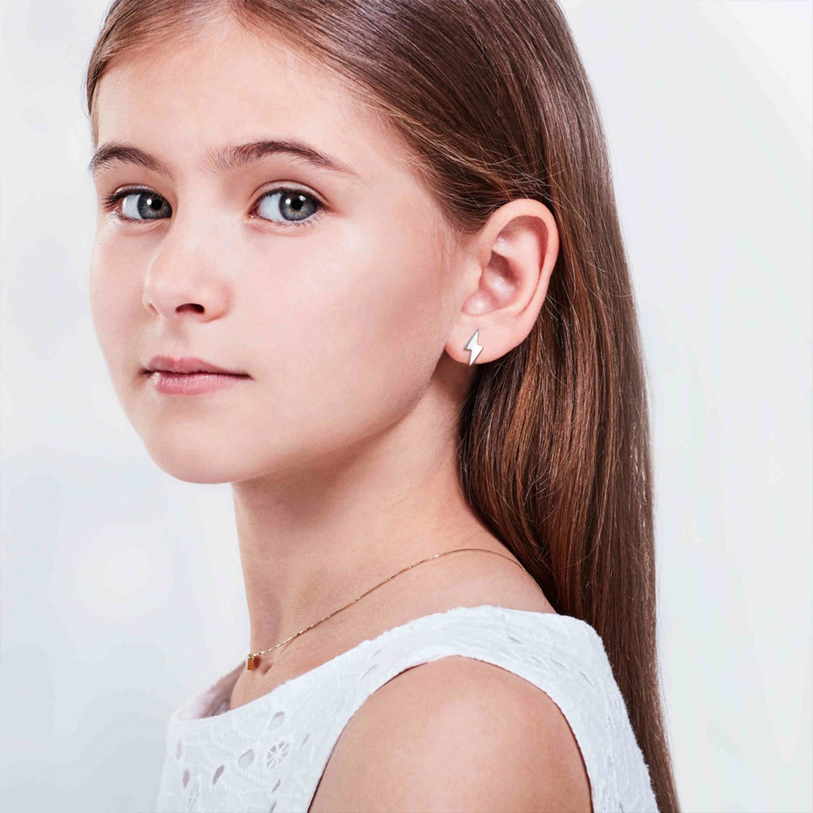 Girl wearing sterling silver lightning bolt earrings