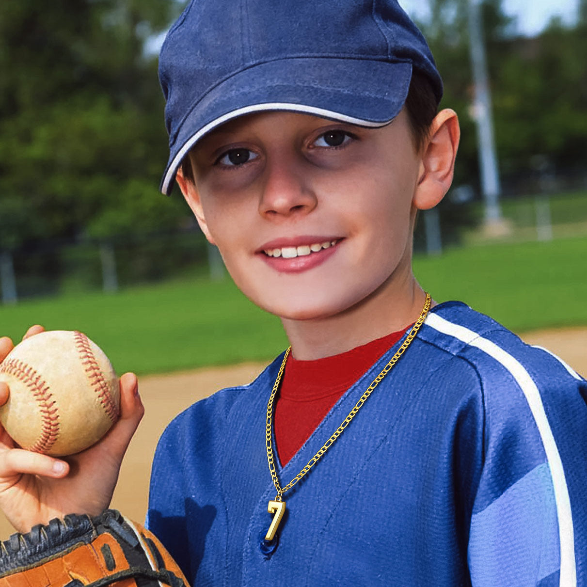 Boy wearing sports jersey number 7 pendant necklace, baseball in hand