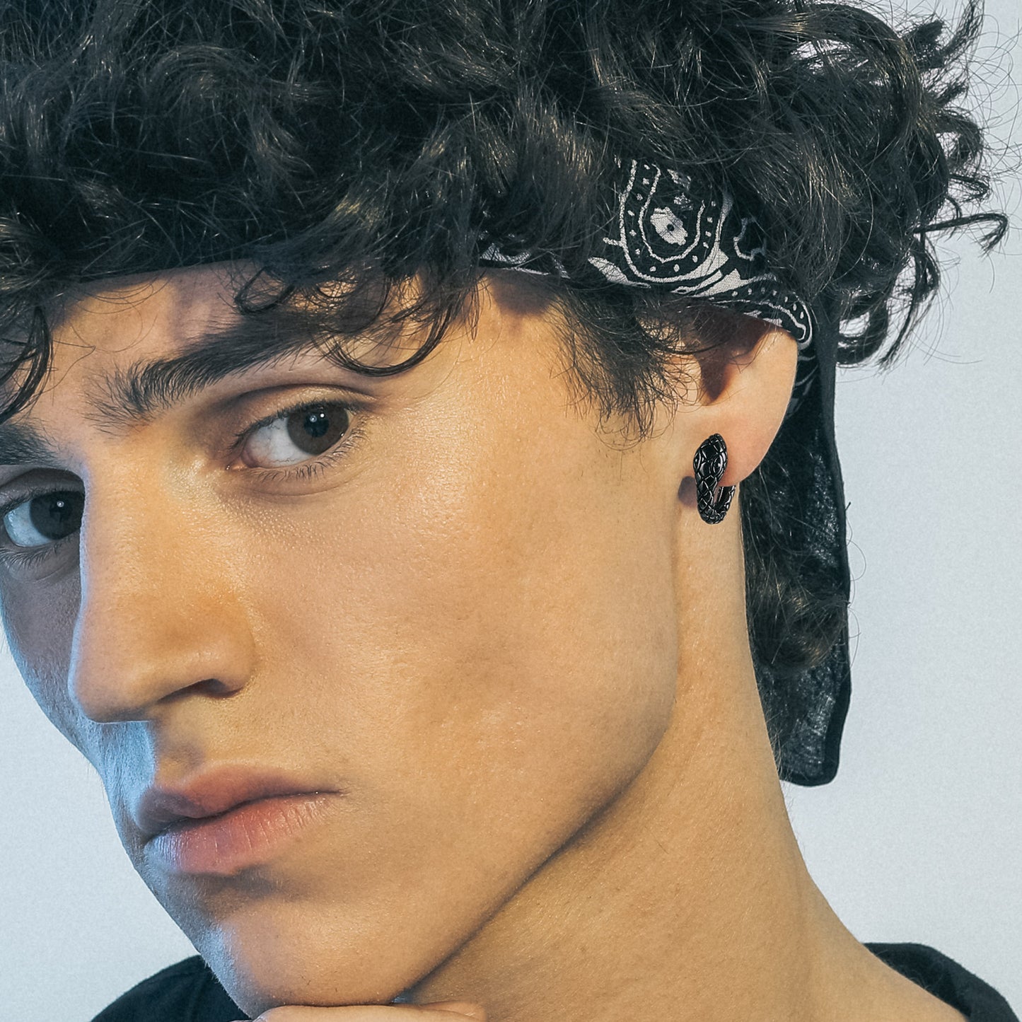 Man wearing gothic snake hoop earring