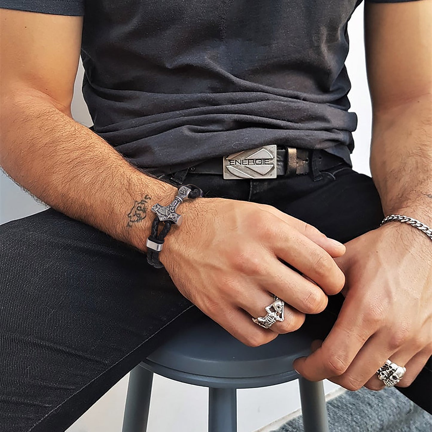Man wearing Thor's Hammer Mjolnir bracelet and rings