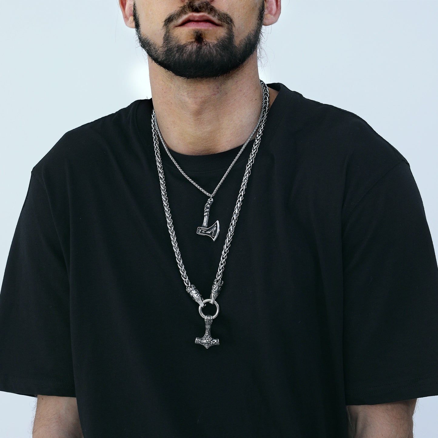 Man wearing Viking Thor's Hammer Mjolnir necklace and axe pendant necklace