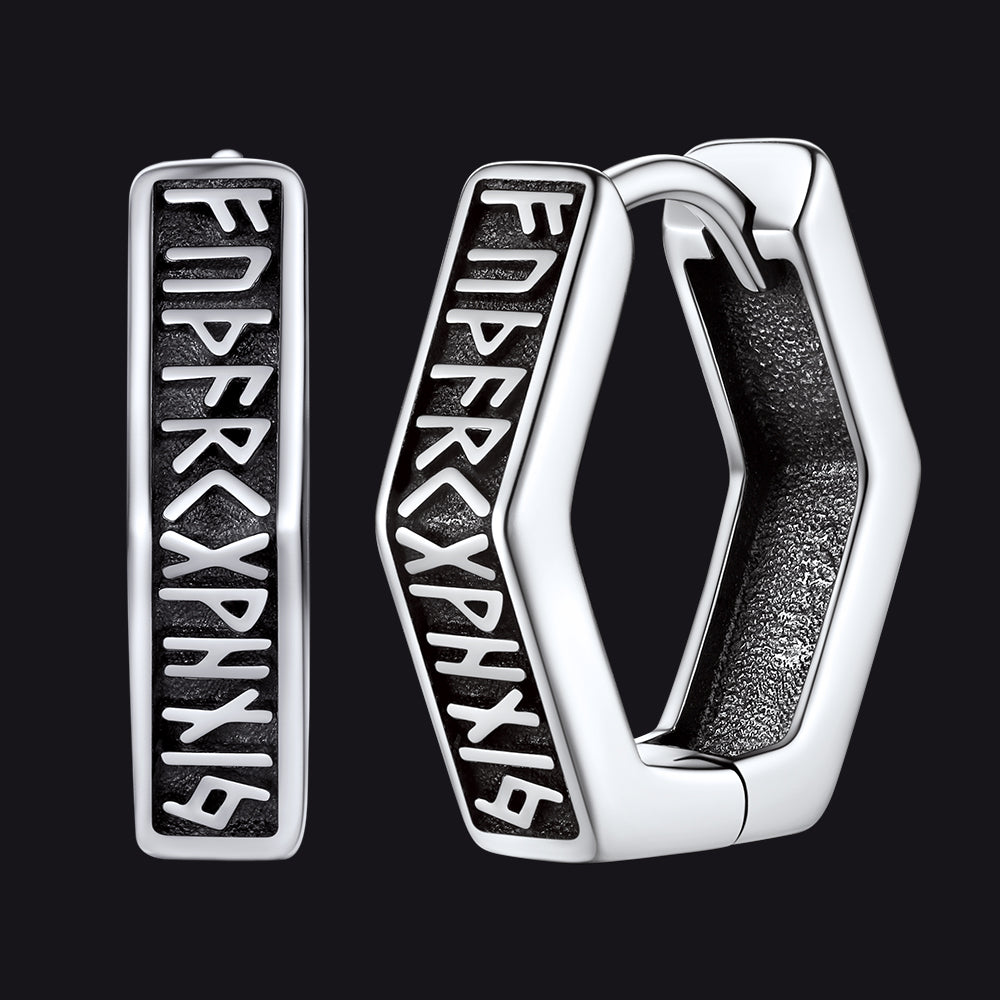 Silver hoop earrings with engraved text on a black background