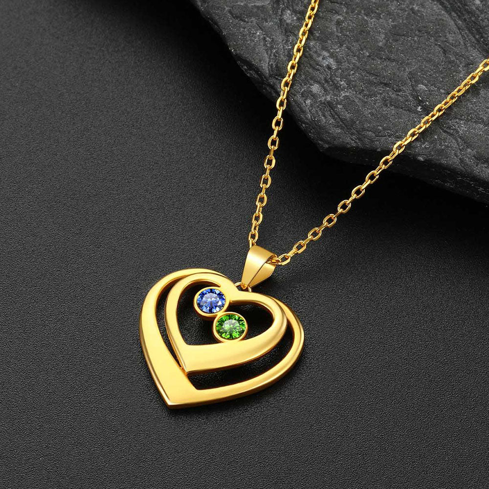 Gold heart-shaped pendant with embedded birthstone