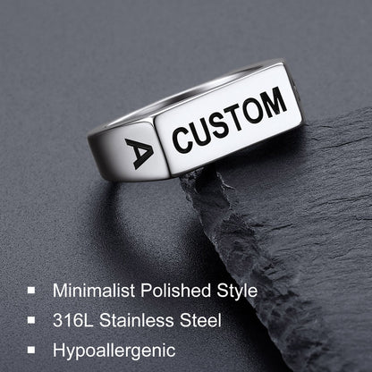 Silver ring with 'CUSTOM' engraving on a dark surface