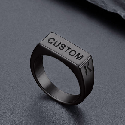 Black ring with 'CUSTOM' and a letter 'K' on a gray background