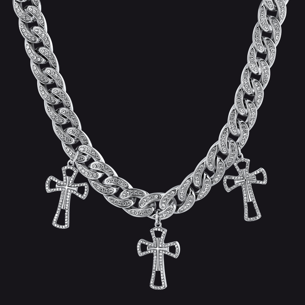 Silver chain necklace with cross pendants on a black background
