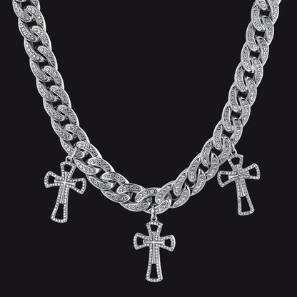 Silver chain necklace with cross pendants on a black background